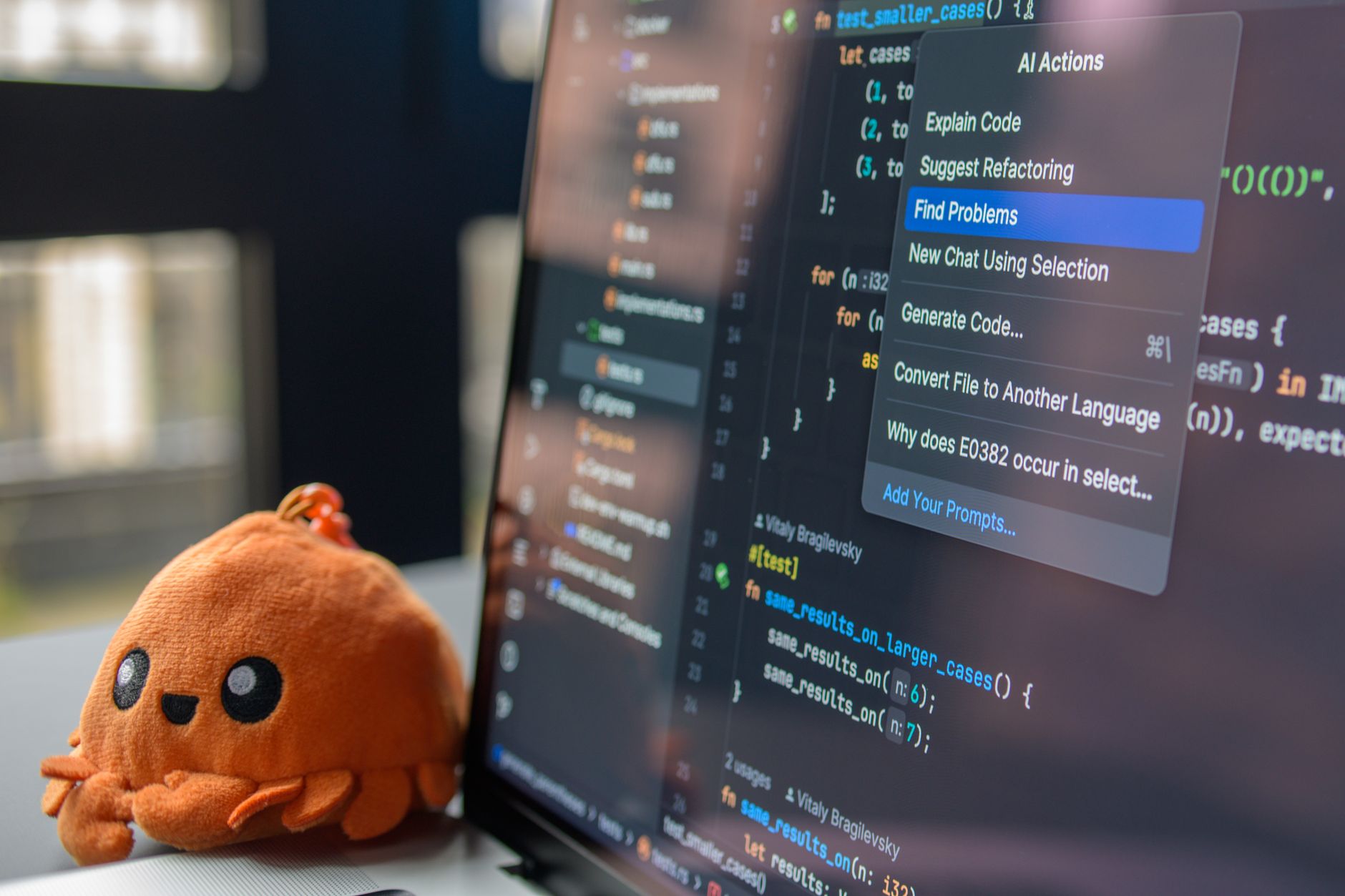 Programmer at a desk using a code editor with AI suggestions on screen