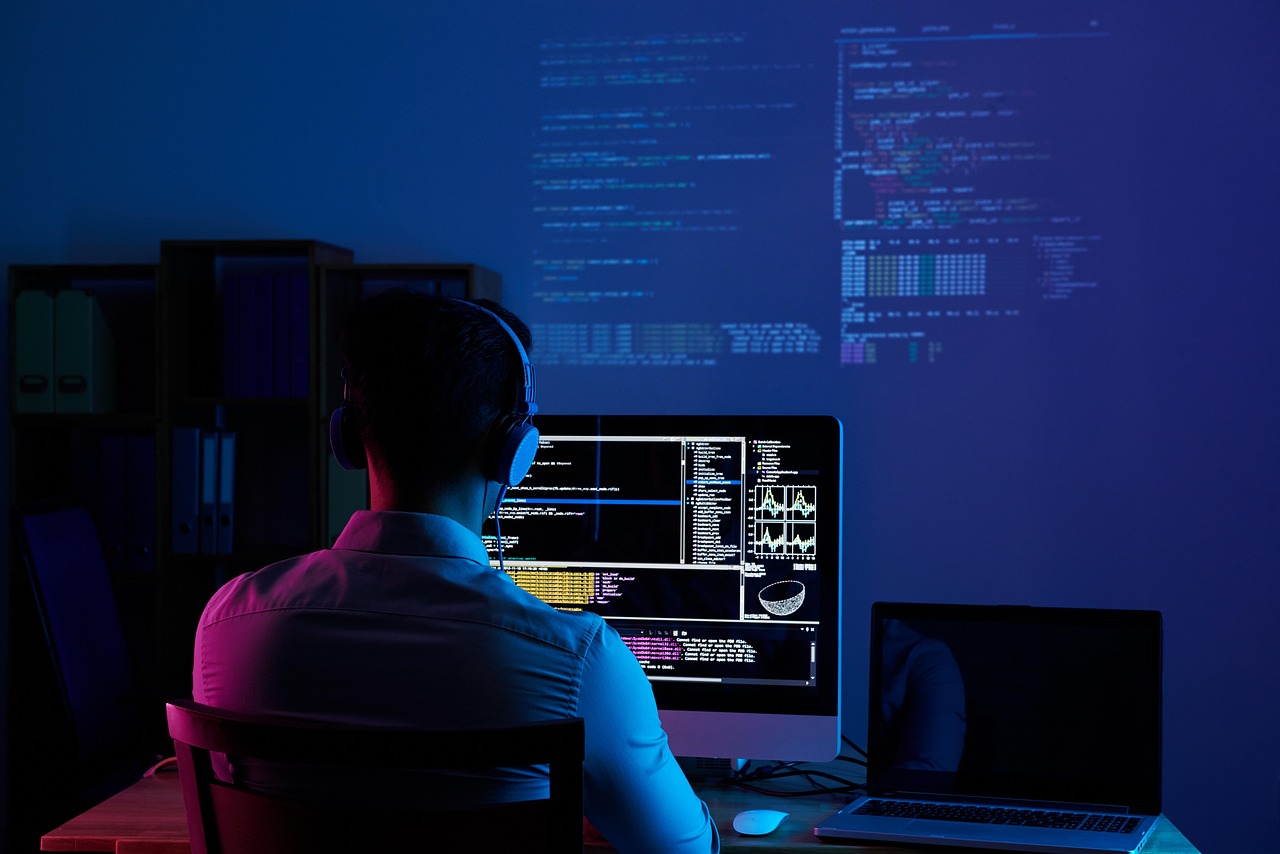 Developer reviewing AI generated code on a large monitor in a home office