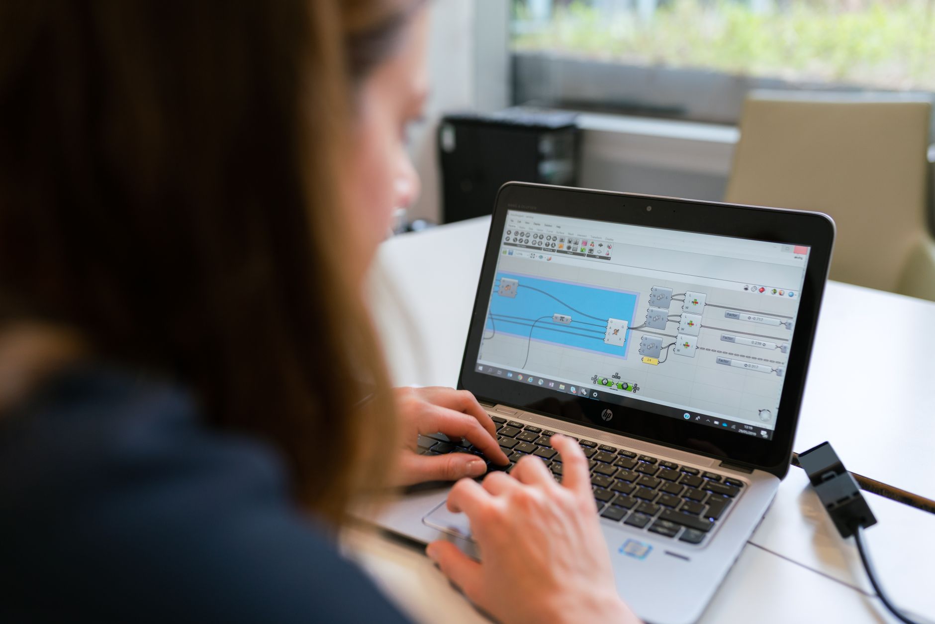 Developer building workflow automation with connected nodes on laptop screen